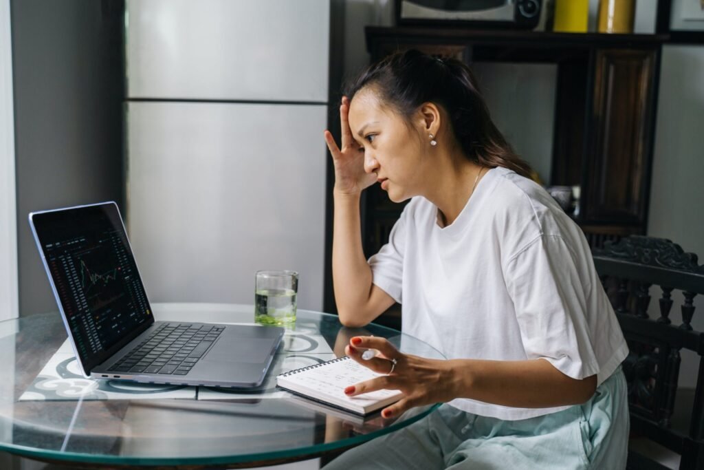 Woman Looking at Cryptocurrency Charts on Her Laptop